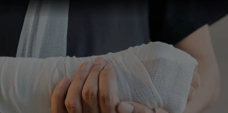 Close-up of a person’s hand wrapped in white medical gauze and bandages.